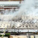 Huge waste facility fire shuts Tube and train lines - BBC