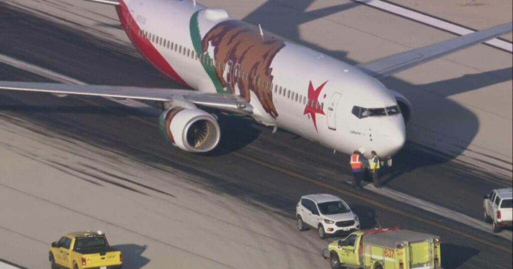 Southwest flight lands safely at Midway International Airport after nose gear tires blow out - CBS News