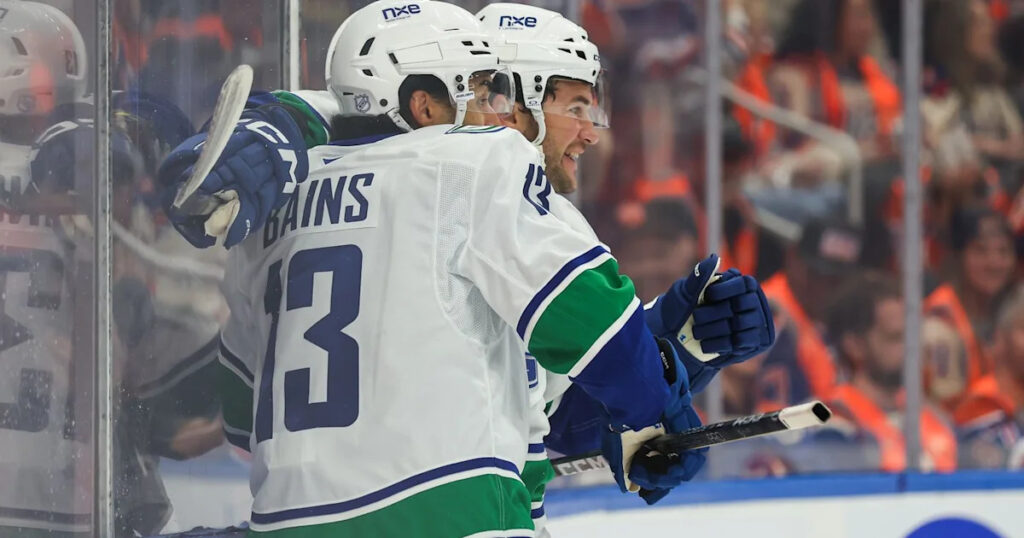 Cotter's OT winner caps two-goal night as Canucks outlast Oilers 6-5 to start season - Yahoo