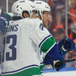 Cotter's OT winner caps two-goal night as Canucks outlast Oilers 6-5 to start season - Yahoo
